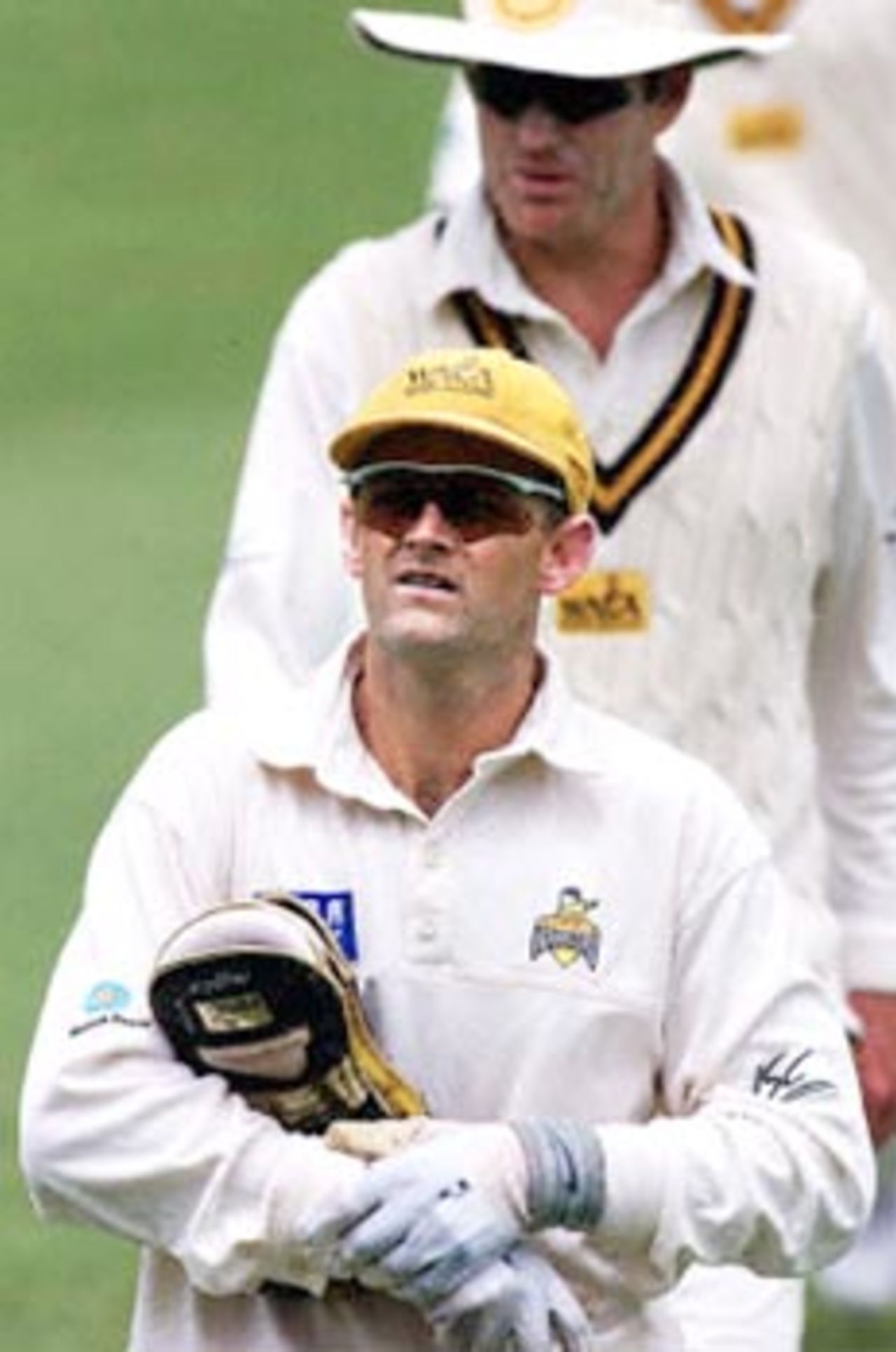 Australian test and one-day wicketkeeper Adam Gilchrist (bottom) leads Tom Moody (top) both from the Western Warriors (a West Australian state side), off the field at lunch during a four-day match against the touring West Indies test cricket side at the WACA ground in Perth 09 November. Gilchrist has taken four catches, with the West Indies getting away to a bad start, being 4/64 at lunch, with Shivnarine Chanderpaul not out on 21 and Ramnaresh Sarwan not out on 19.