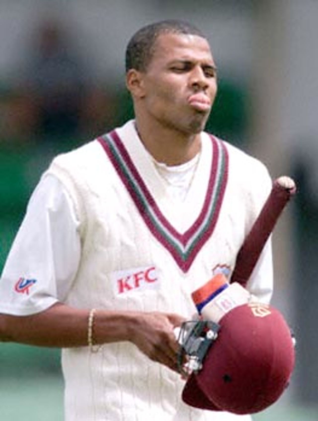Mervyn Dillon from the West Indies pokes out his tongue as he walks from the WACA ground, after making a duck against the Western Warriors (a West Australian state side) at the WACA ground in Perth 09 November. Dillon was caught by Tom Moody off the bowling of Gavin Swan, with the West Indies currently on 9 for 132.