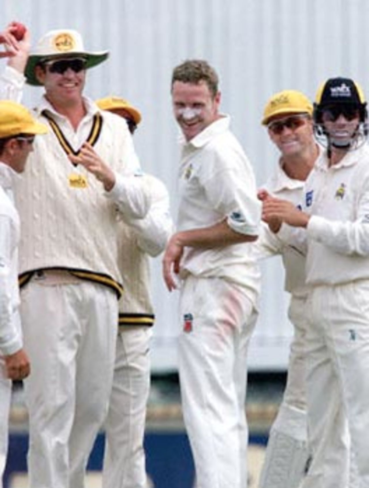 Gavin Swan (C) is all smiles after taking his third wicket for the Western Warriors (a West Australian state side) against the West Indies during a four day match at the WACA ground in Perth 09 November. Swan had just taken the wicket of Mervyn Dillon for no run, caught by Warriors skipper Tom Moody (holding ball, 2nd L), with the West Indies currently 9 for 132.