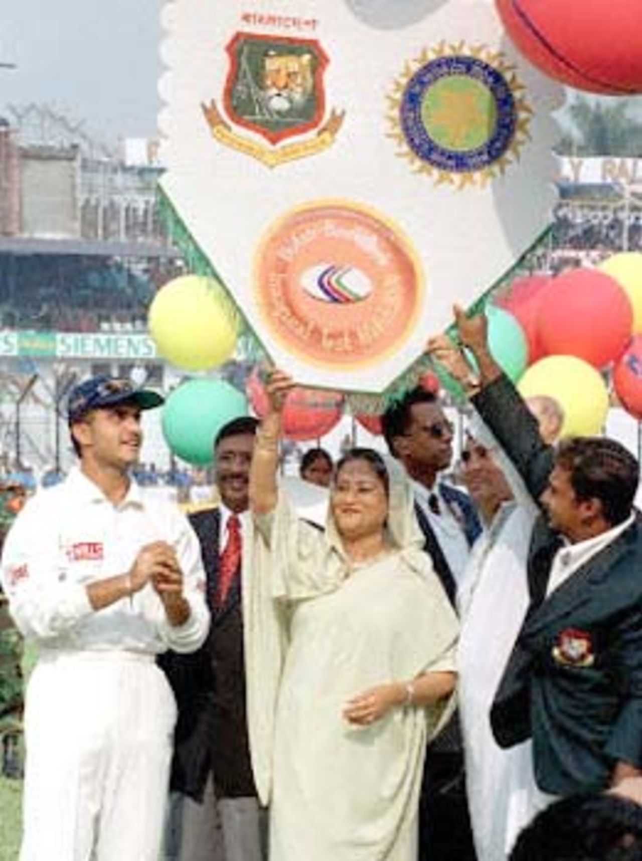 Bangladeshi Prime Minister Sheikh Hasina Wajed (C) releases a banner with colourful balloons 10 November 2000 in Dhaka, flanked by Indian skipper Saurav Ganguly (L) and his Bangladeshi counterpart Naimur Rahman (R). at this South Asian country's inaugural Test match against India. Bangladesh won the toss and elected to bat.
