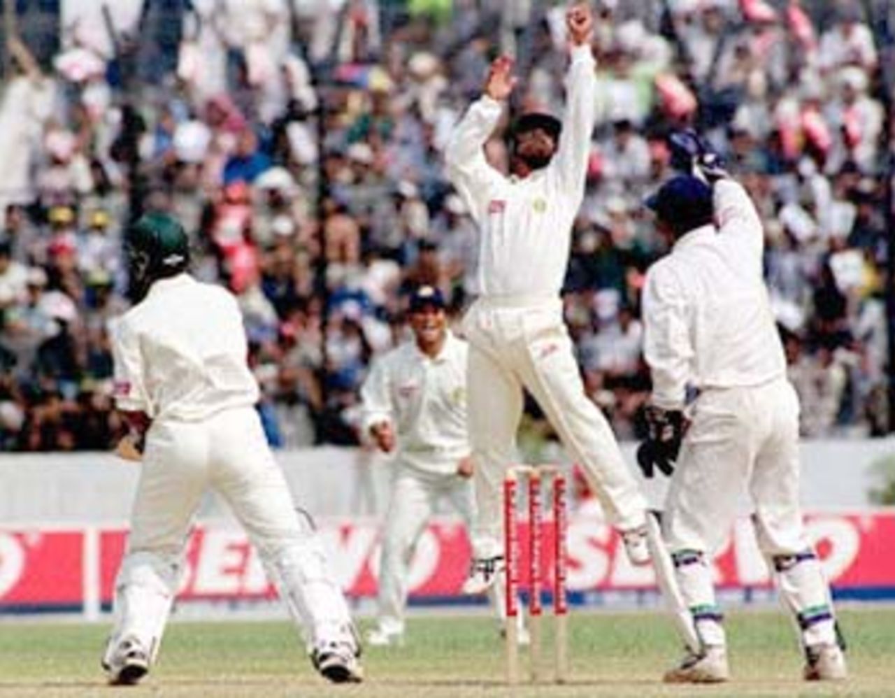 Indian fielder S.S Das (2nd from R) jumps to catch a ball off Sunil Joshi hit by Bangladeshi batsman Habibul Bashar (L-rear) as Sachin Tendulker (R) and Saba Karim (L) shouts 10 November 2000 at the Bangabandhu National Stadium during this South Asian country's inaugural Test match against India. Bashar hit 71, before being caught by Indian skipper Sourav Ganguly off Zahir Khan. Bangladesh won the toss and elected to bat.