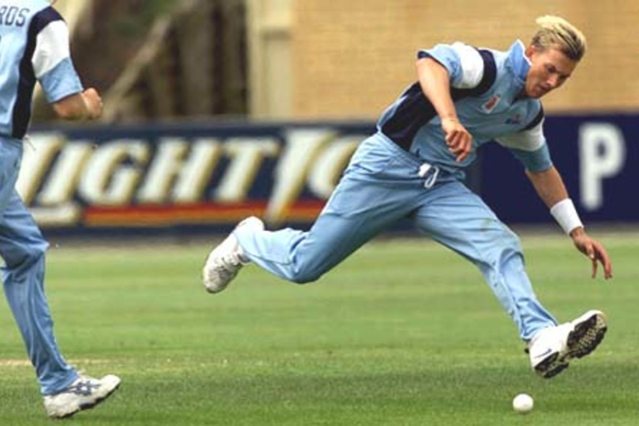 11 Nov 2000: Brett Lee from New South Wales fields the ball just before rolling his ankle during the Mercantile Mutual Cup Cricket match between Tasmania and New South Wales at Bellerive Oval in Hobart, Australia.