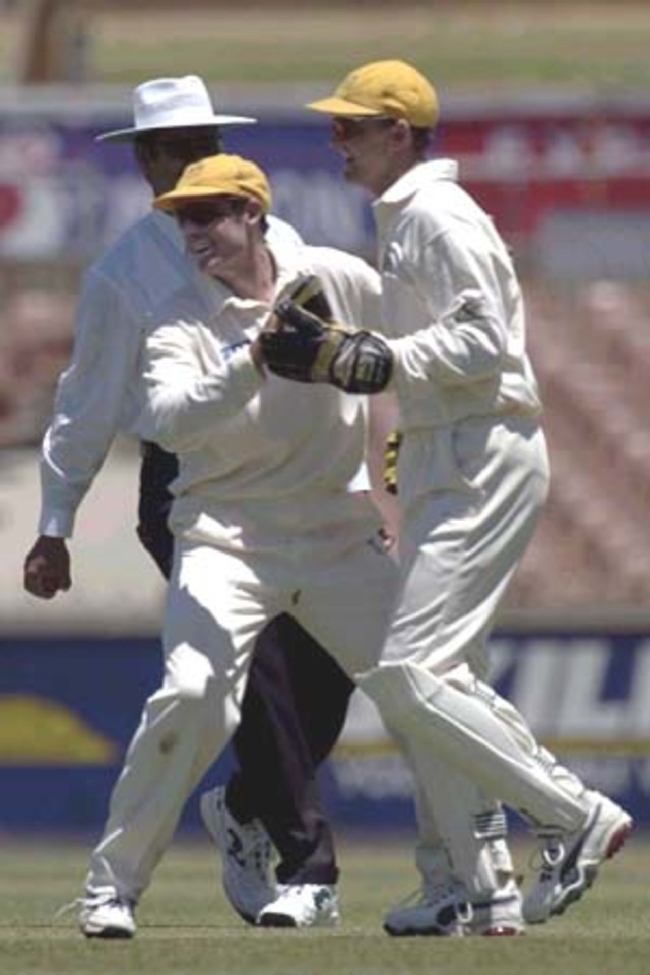 11 Nov 2000: Michael Hussey and wicket keeper Adam Gilchrist for Western Australia, celebrate taking the wicket of Wavell Hinds of the West Indies for 27 in the match between the Western Warriors and the West Indies at the WACA ground in Perth, Australia.
