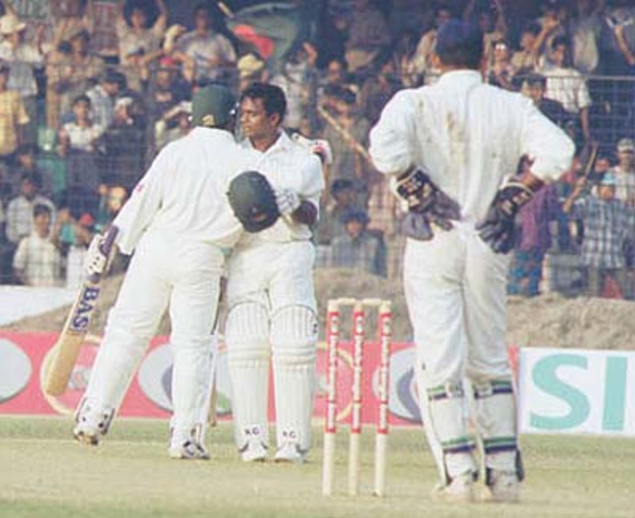 Aminul Islam congratulates Bashar on scoring fifty. India in Bangladesh 2000/01, Only Test, Bangladesh v India Bangabandhu National Stadium, Dhaka, 10-14 Nov 2000 (Day 1)