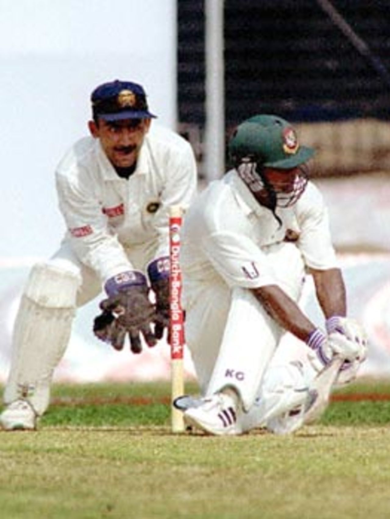 Bangladeshi bastman Aminul Islam (R) hits a ball off Indian spiner Murli Kartick (not in picture) for one run to make a century 11 November 2000 at the Bangabandhu National Stadium on the second day of Bangladesh's inaugural Test match against India. Aminul created history by becoming the third man to score a century in an inaugural Test match. Bangladesh scored 302 for six at lunch on the day in their debut match.