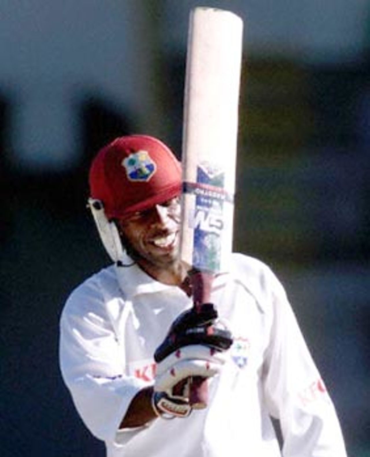 West Indies batsman and vice-captain Sherwin Campbell shows his bat to teammates after scoring a century during a four-day match against the Western Warriors at the WACA ground in Perth 11 November 2000. Campbell is currently not out on 114, with the West Indies on 4-230.