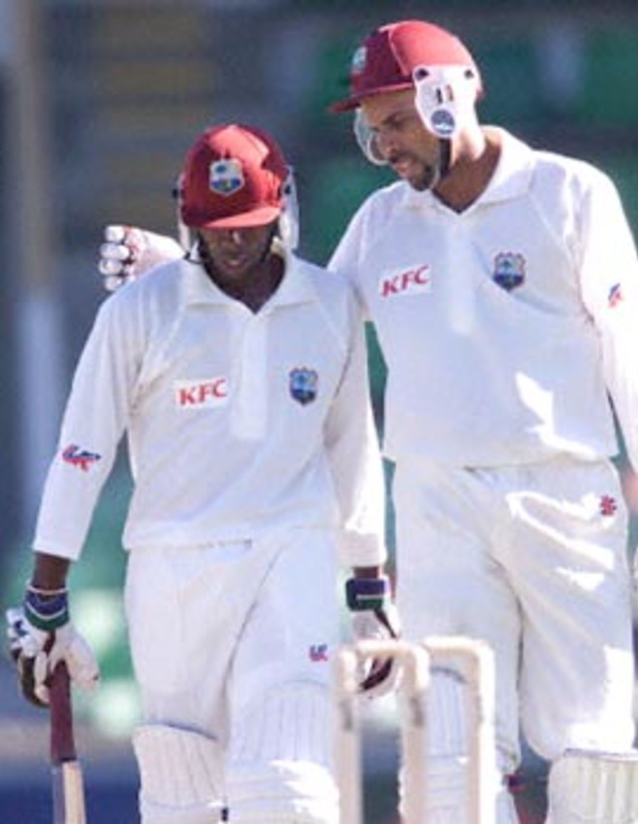 West Indies captain Jimmy Adams (R) congratulates vice-captain Sherwin Campbell (L) on reaching his 100 during a four day match against the Western Warriors at the WACA ground in Perth 11 November 2000. Campbell was eventually out for 119 and at stumps on day three, the West Indies are 6-266 with Adams not out on 41.