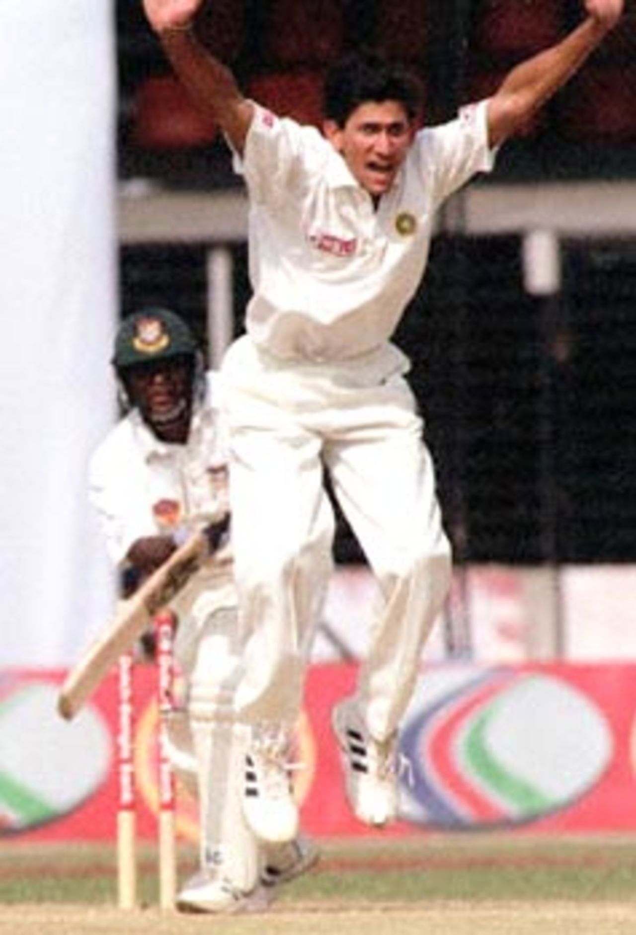 Indian bowler Ajit Agarkar (C-front) jumps and shout for LBW against Bangladeshi batsman Aminul Islam (L-back) 13 November 2000 at the Bangabandhu National Stadium on the fourth day of this South Asian country's inaugural Test match against India. India won by nine wickets by the end of the fourth day's play of the five day test match.
