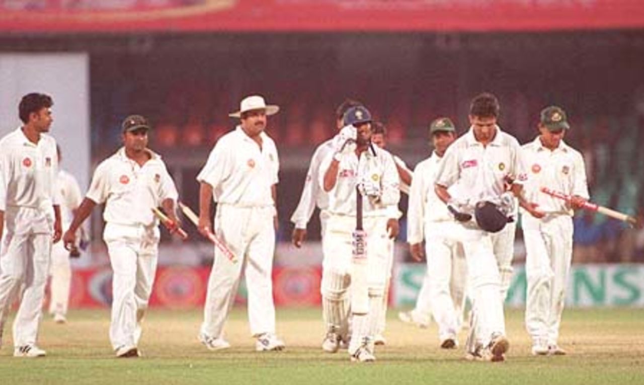 Bangladesh players clutch souveneirs as Dravid and Das lead them off the field at the end of the Test. India in Bangladesh 2000/01, Only Test, Bangladesh v India Bangabandhu National Stadium, Dhaka, 10-14 Nov 2000 (Day 4)