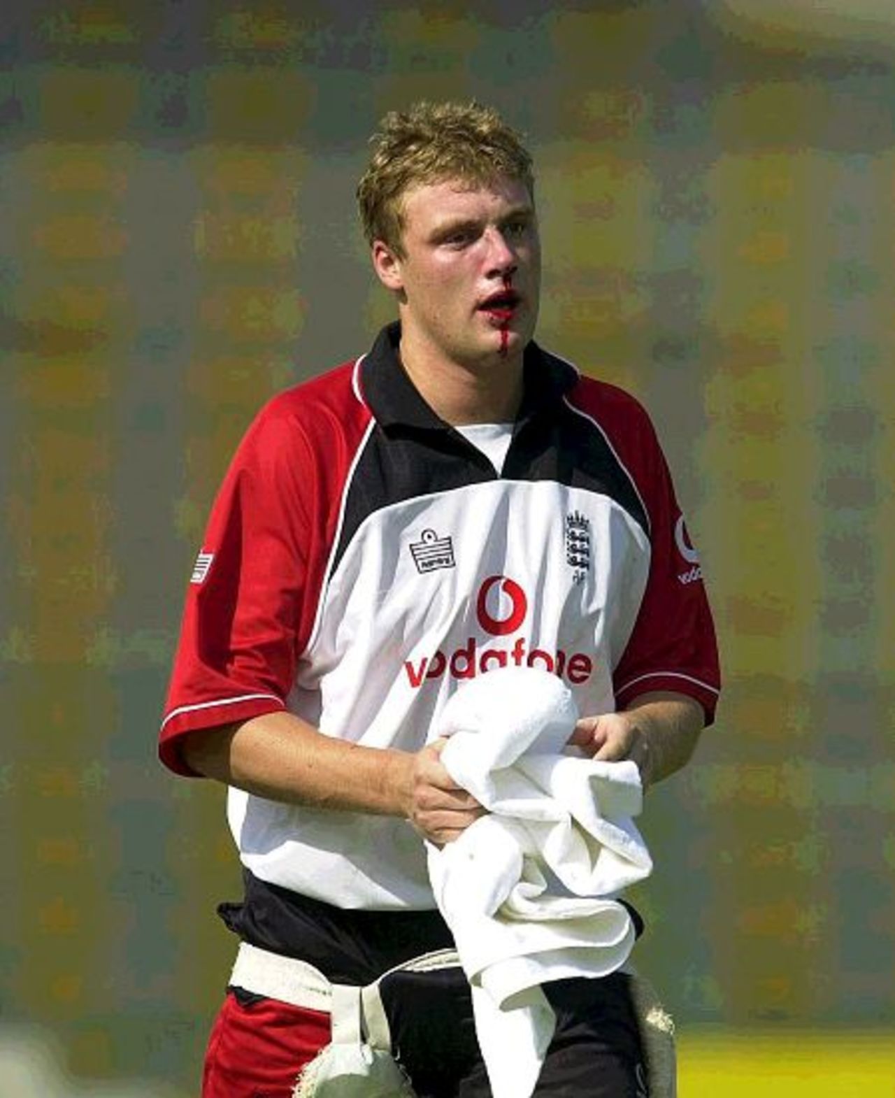 14 Nov 2000: Andrew Flintoff of England walks back the pavilion after being hit in the face with a ball during the England nets session prior to the 1st Test against Pakistan at the Gadaffi Stadium, Lahore, Pakistan.