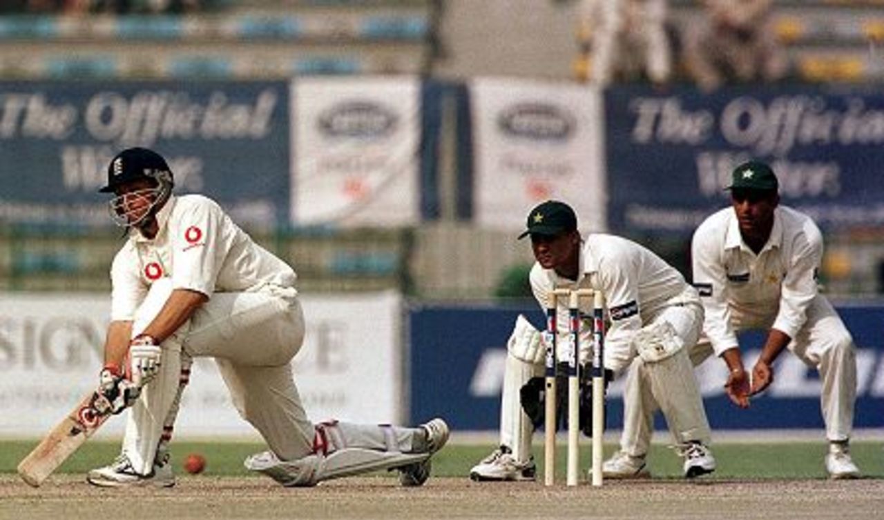 17 Nov 2000: Ashley Giles of England sweeps the ball during the 3rd days play in the first Test match between Pakistan and England at the Gaddafi stadium in Lahore, Pakistan.