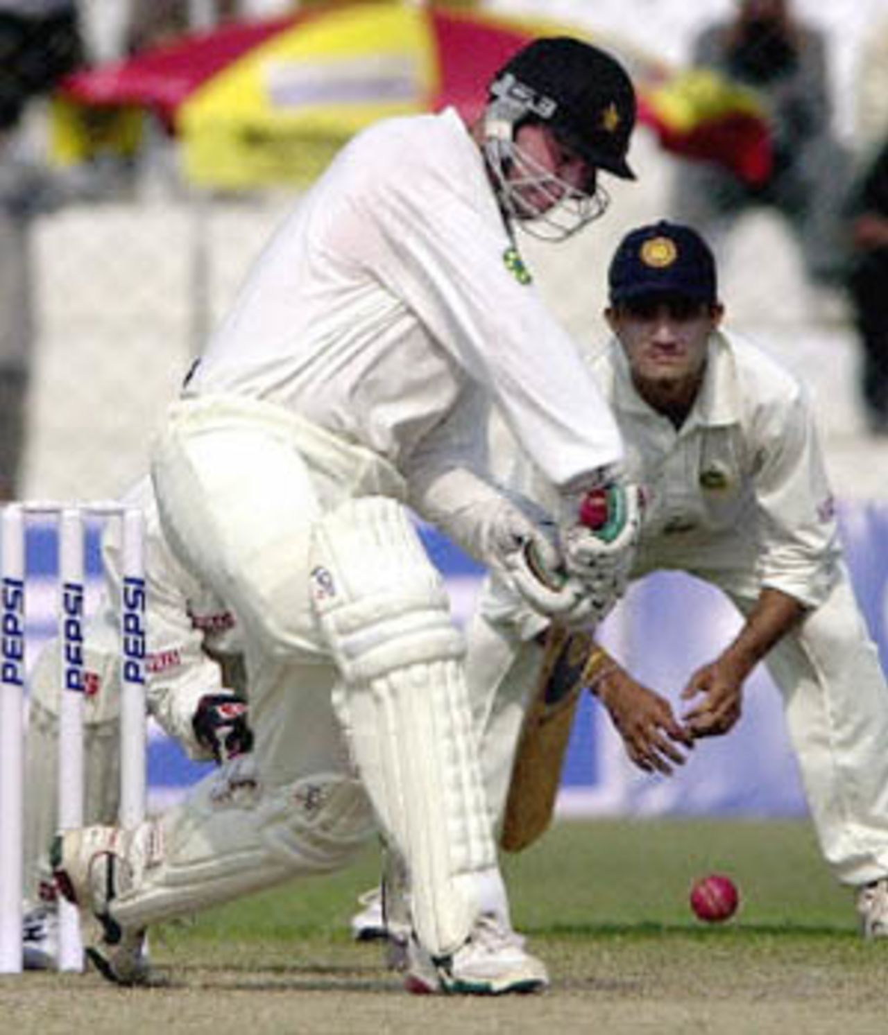 Campbell launches himself on the drive as Ganguly watches, Zimbabwe in India, 2000/01, 1st Test, India v Zimbabwe, Feroz Shah Kotla, Delhi, 18-22 November 2000 (Day 1).