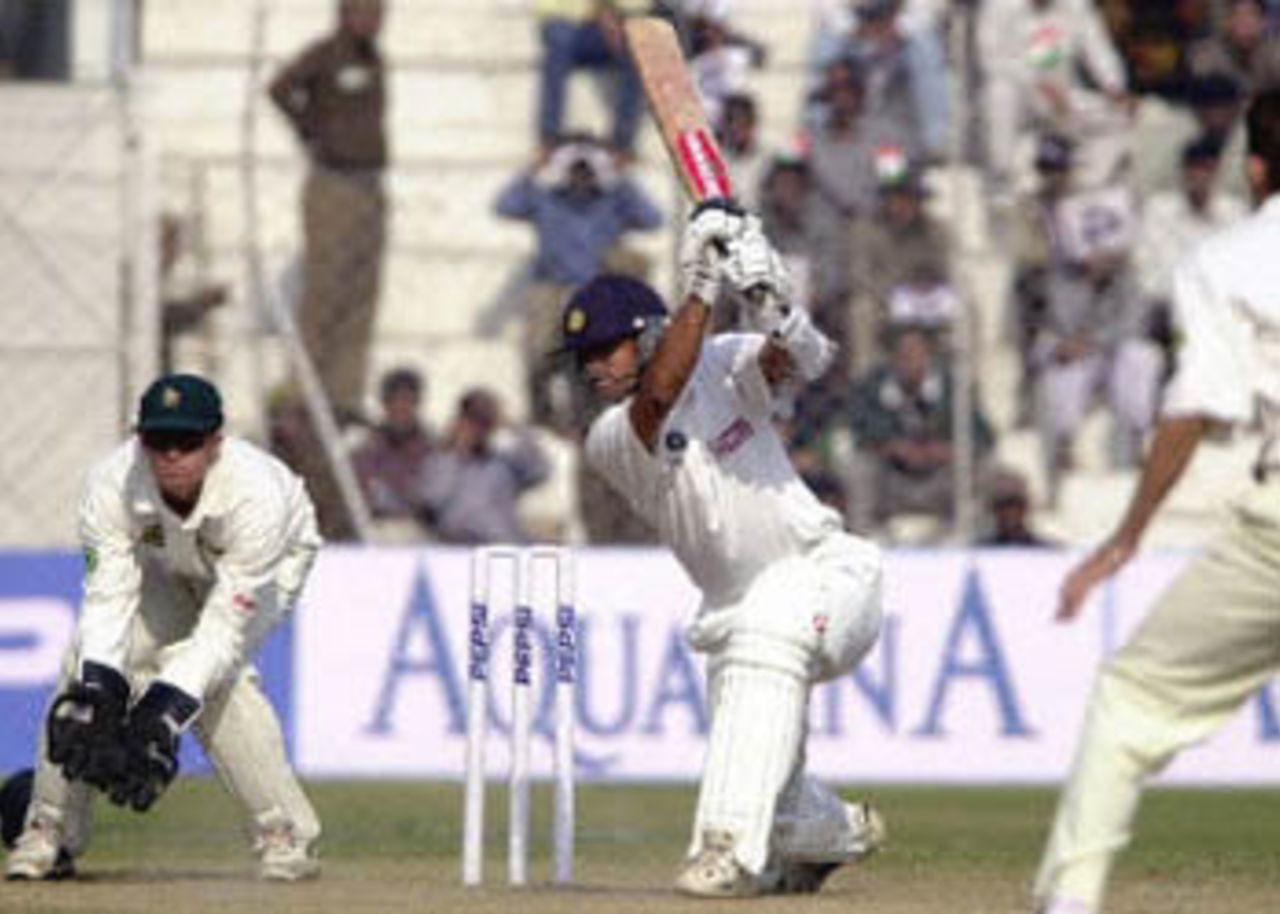 Dravid drives the ball through the off side as Flower watches, Zimbabwe in India, 2000/01, 1st Test, India v Zimbabwe, Feroz Shah Kotla, Delhi, 18-22 November 2000 (Day 3).