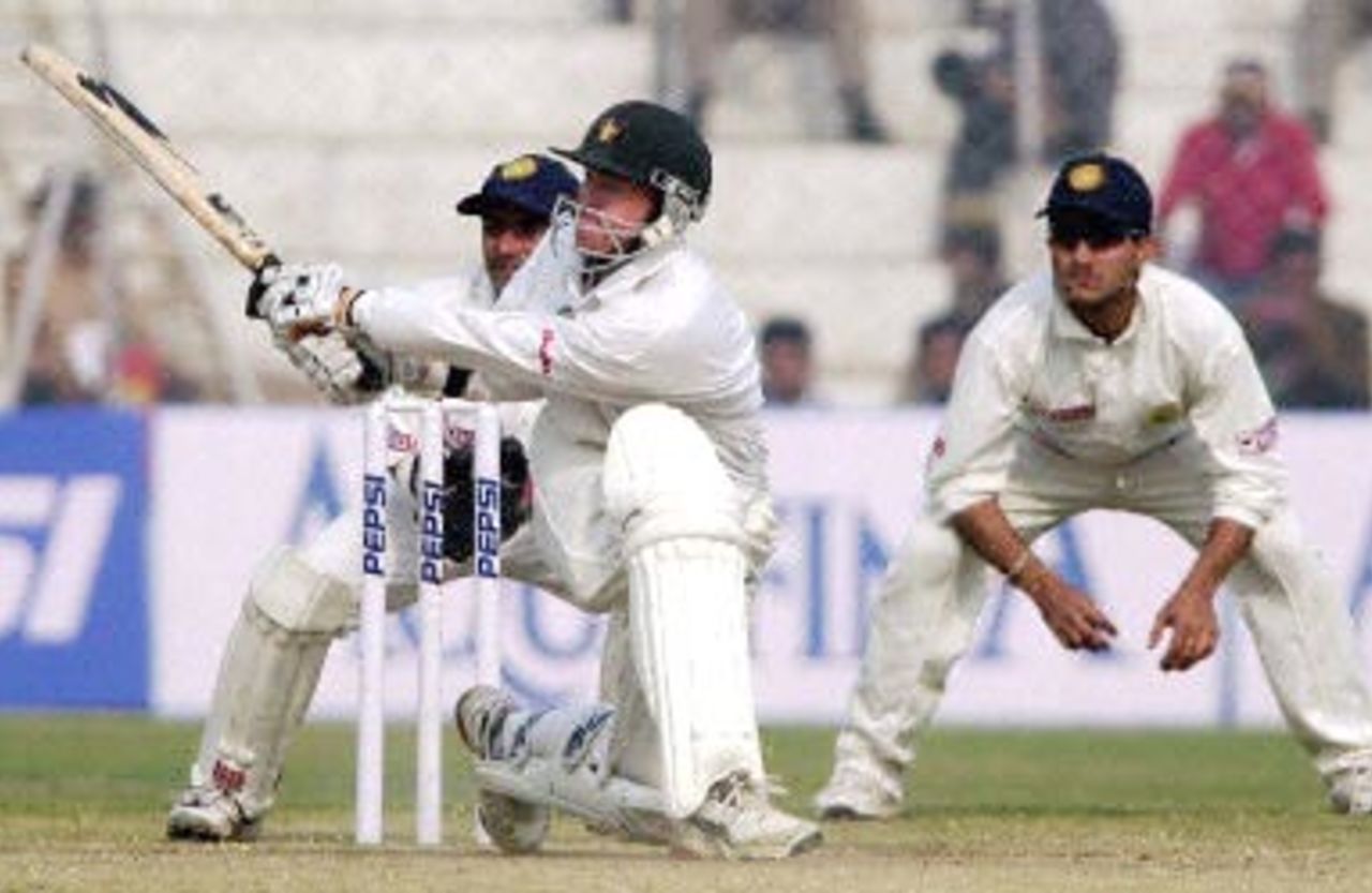 Flower plays the sweep as Dahiya and Ganguly watch keenly. Zimbabwe in India 2000/01, 1st Test, India v Zimbabwe Feroz Shah Kotla, Delhi, 18-22 November 2000 (Day 5)