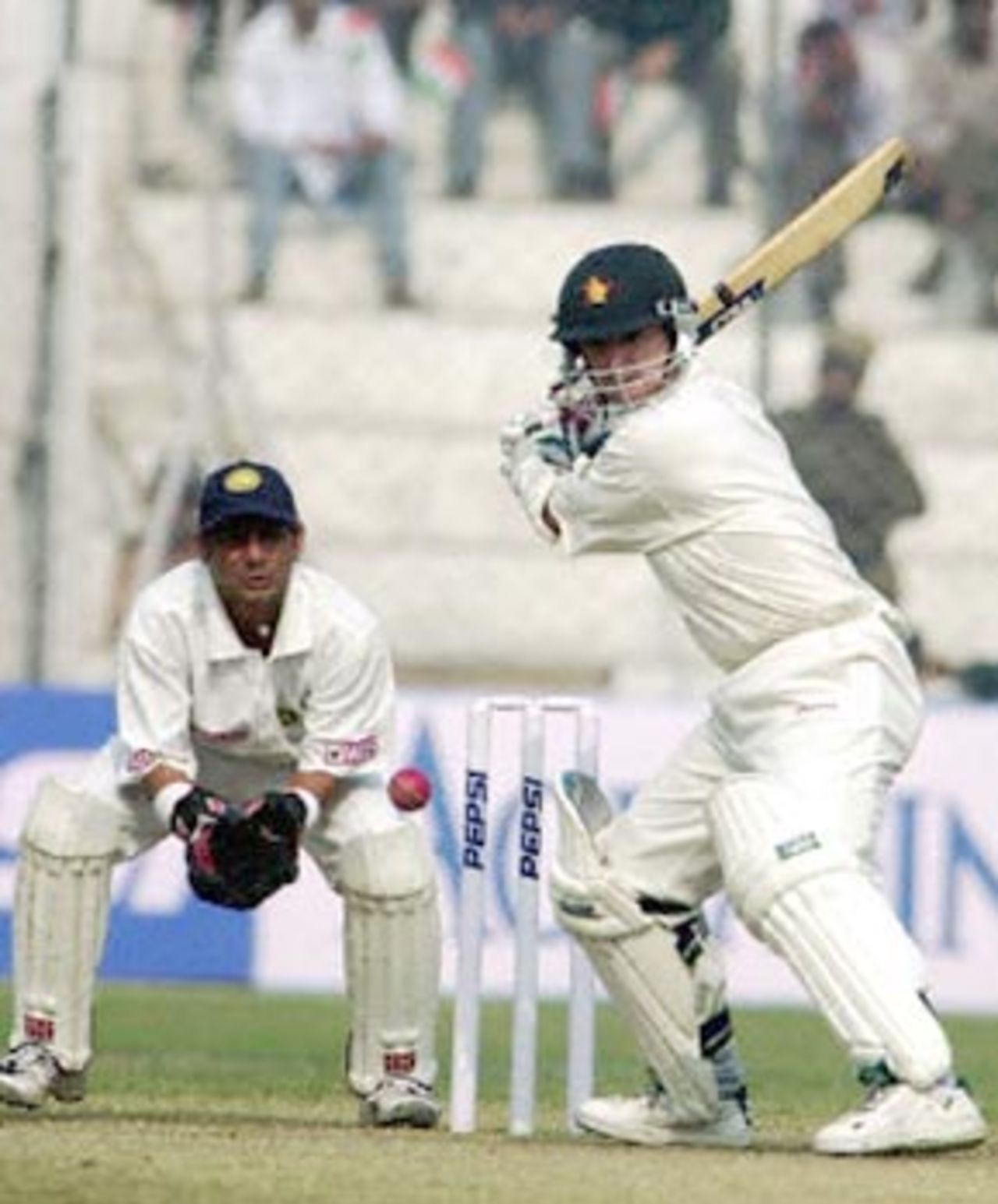 Paul Strang shapes to cut the ball as Dahiya watches. Zimbabwe in India 2000/01, 1st Test, India v Zimbabwe Feroz Shah Kotla, Delhi, 18-22 November 2000 (Day 5)