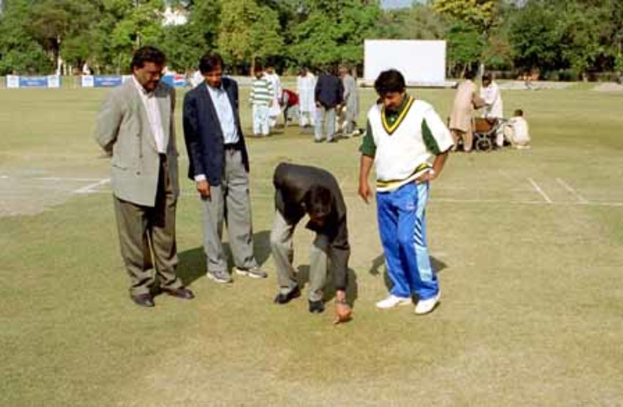 Ground officials examining the pitch after heavy overnight rain, England v PCB XI at Lahore, 23-25 Nov 2000