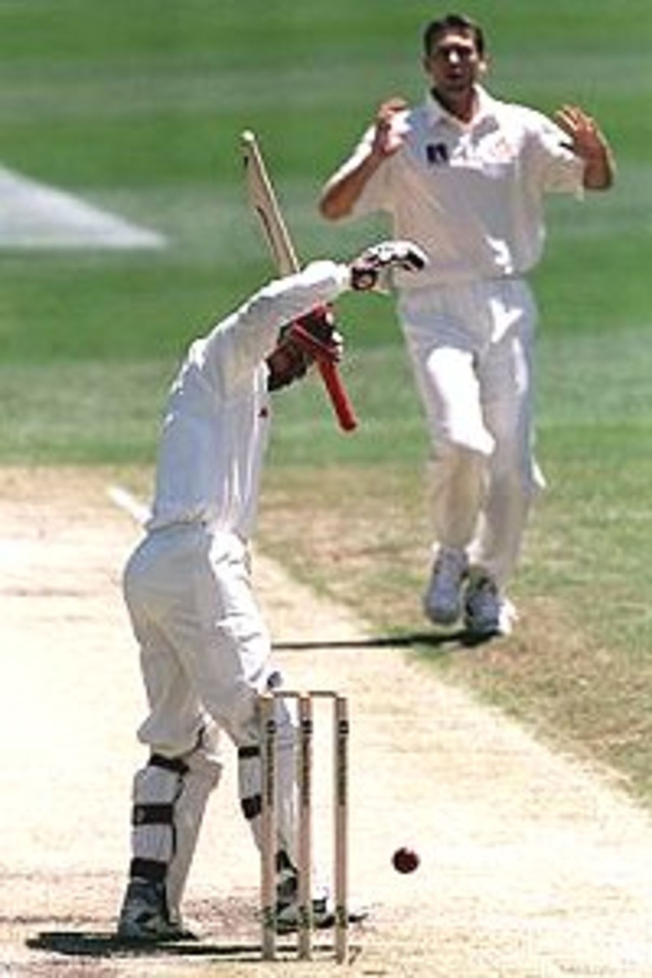 25 Nov 2000: Jimmy Adams of West Indies fends off a bouncer from Glenn McGrath of Australia during the third day of the First Test match between Australia and West Indies at The Gabba cricket ground in Brisbane, Australia.