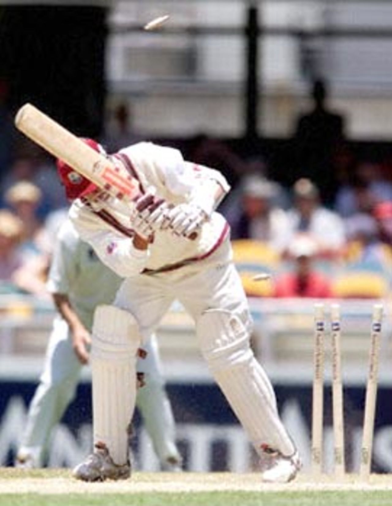 West Indian batsman Ramnaresh Sarwan is clean bowled by Australian fast bowler Brett Lee on the third day of the first Test match at the Gabba in Brisbane, 25 November 2000. At lunch the West Indies were struggling in their second innings at 81-6, still trailing Australia by 169 runs.