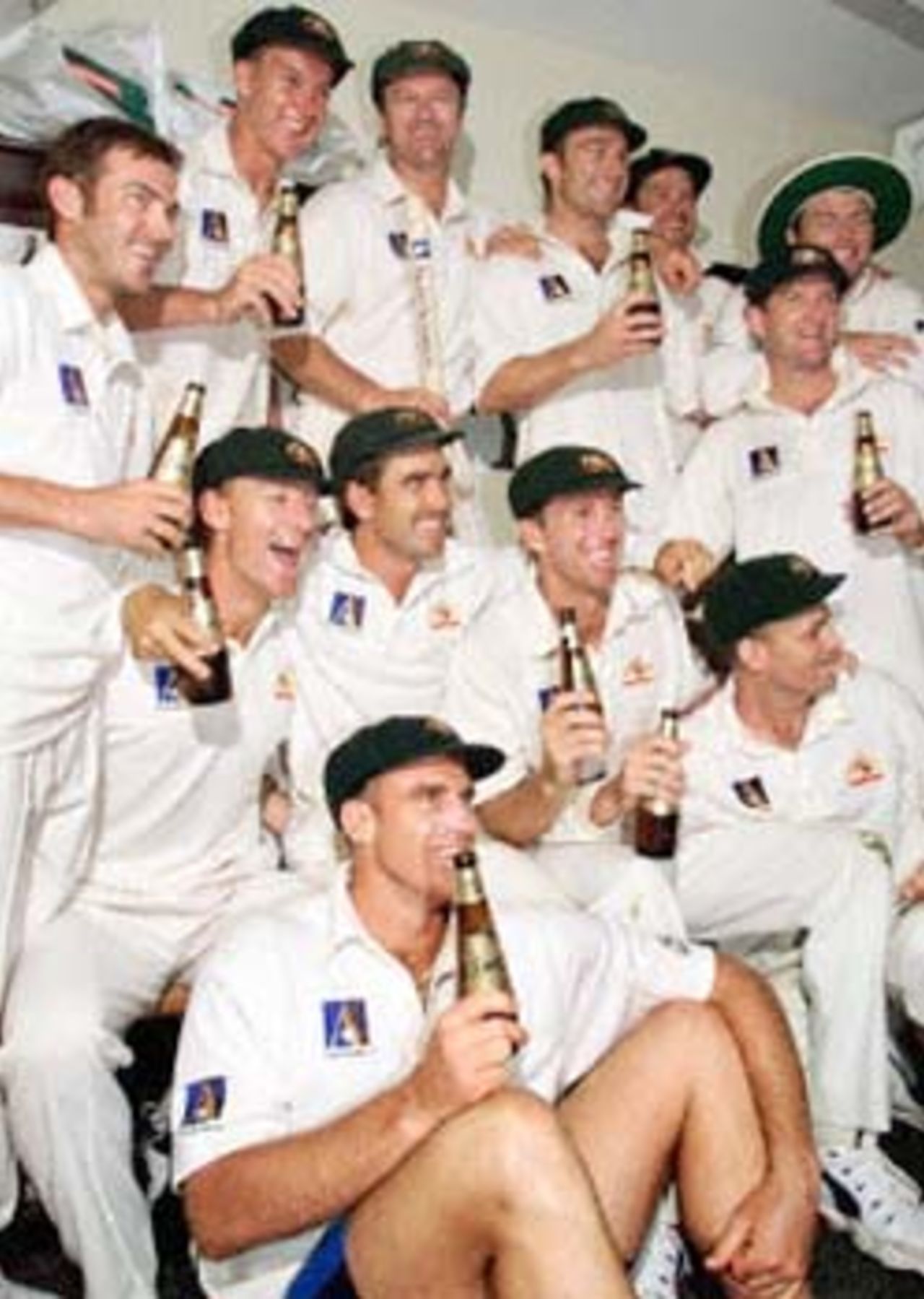 The Australian team celebrates after defeating the West Indies by an inning and 126 runs on the third day of the first Test match at the Gabba in Brisbane, 25 November 2000. The Australian victory equals the world record of eleven consecutive Test victories.