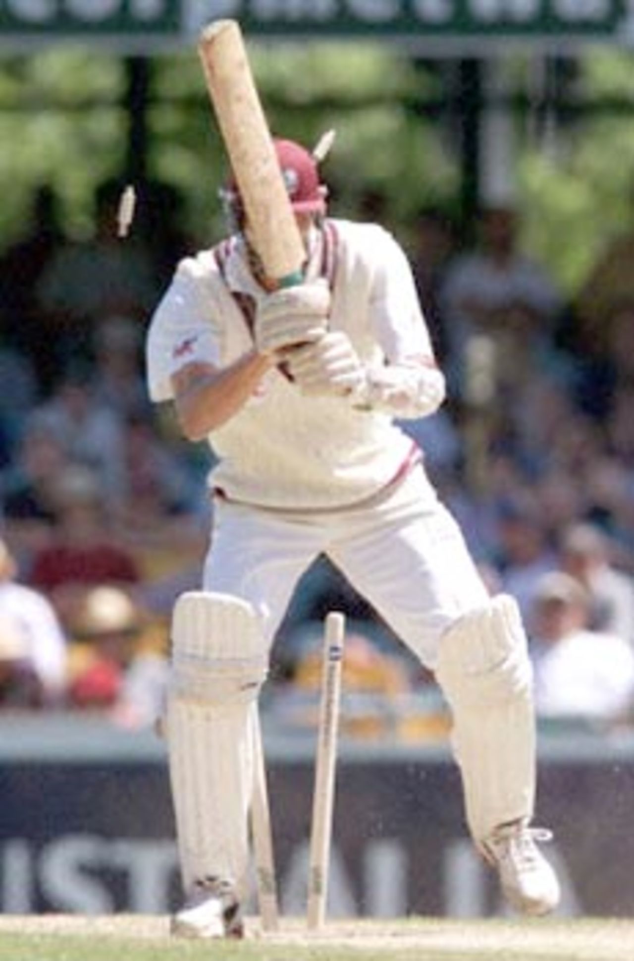West Indian batsman Mervyn Dillion is clean bowled by Australian paceman Glenn McGrath as Australia goes on to defeat the West Indies by an inning and 126 runs, on the third day of the first Test match at the Gabba in Brisbane, 25 November 2000. The Australian victory equals the world record of eleven consecutive Test victories.