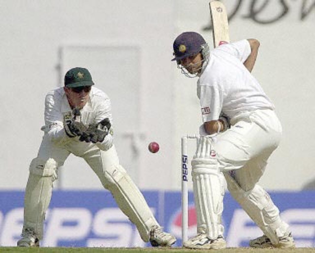 Indian batsman Rahul Dravid (R) about to whip a delivery from Zimbabwean bowler Henry Olonga (not in picture) as wicketkeeper Andy Flower (L) looks on during the first day of the second test match between India and Zimbabwe in Nagpur 25 November 2000. India made 91 for 1 by lunch.