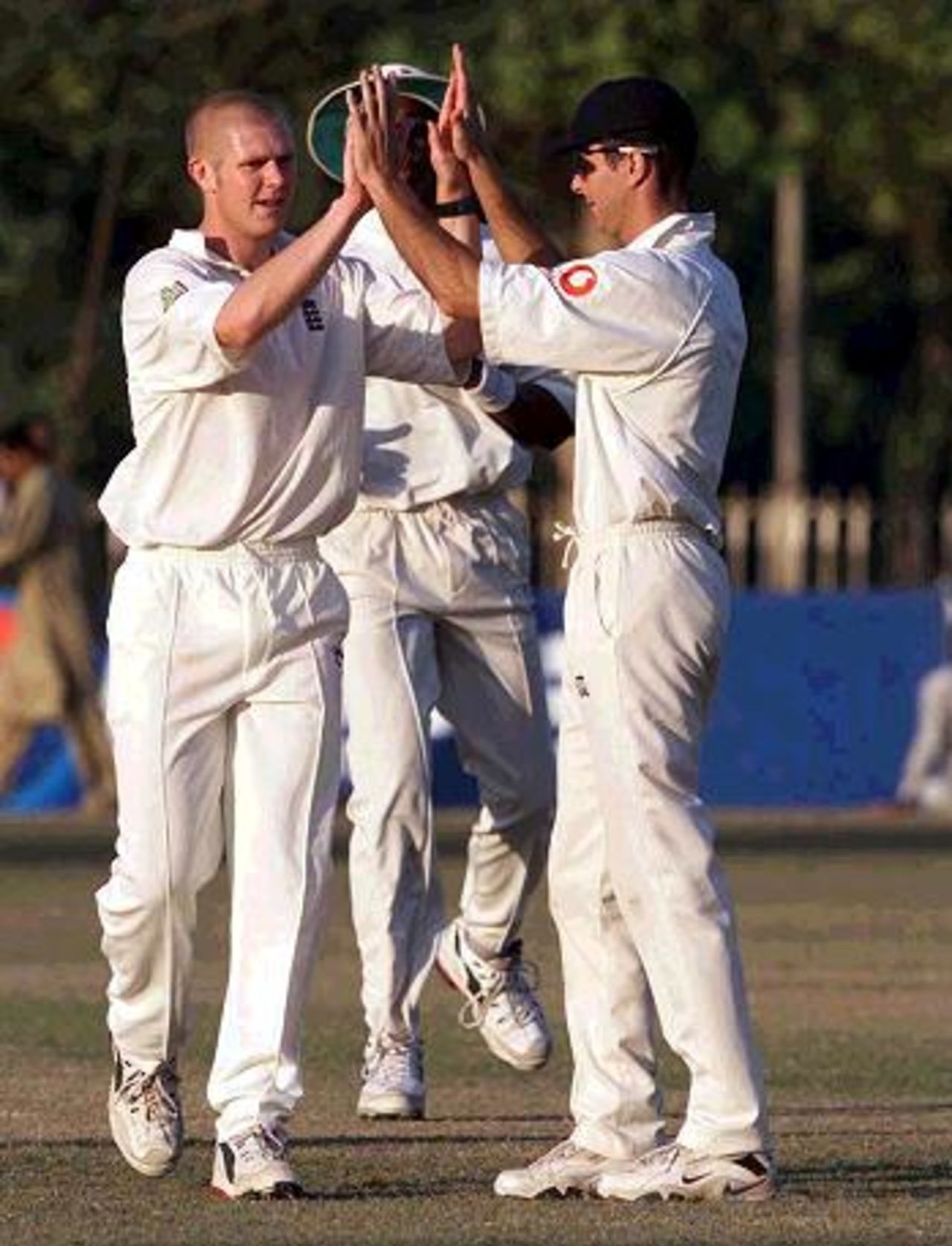 25 Nov 2000: Matthew Hoggard of England celebrates with Michael Vaughan during the match between England and the PCB Board XI at the Lawrence Garden in Lahore, Pakistan.