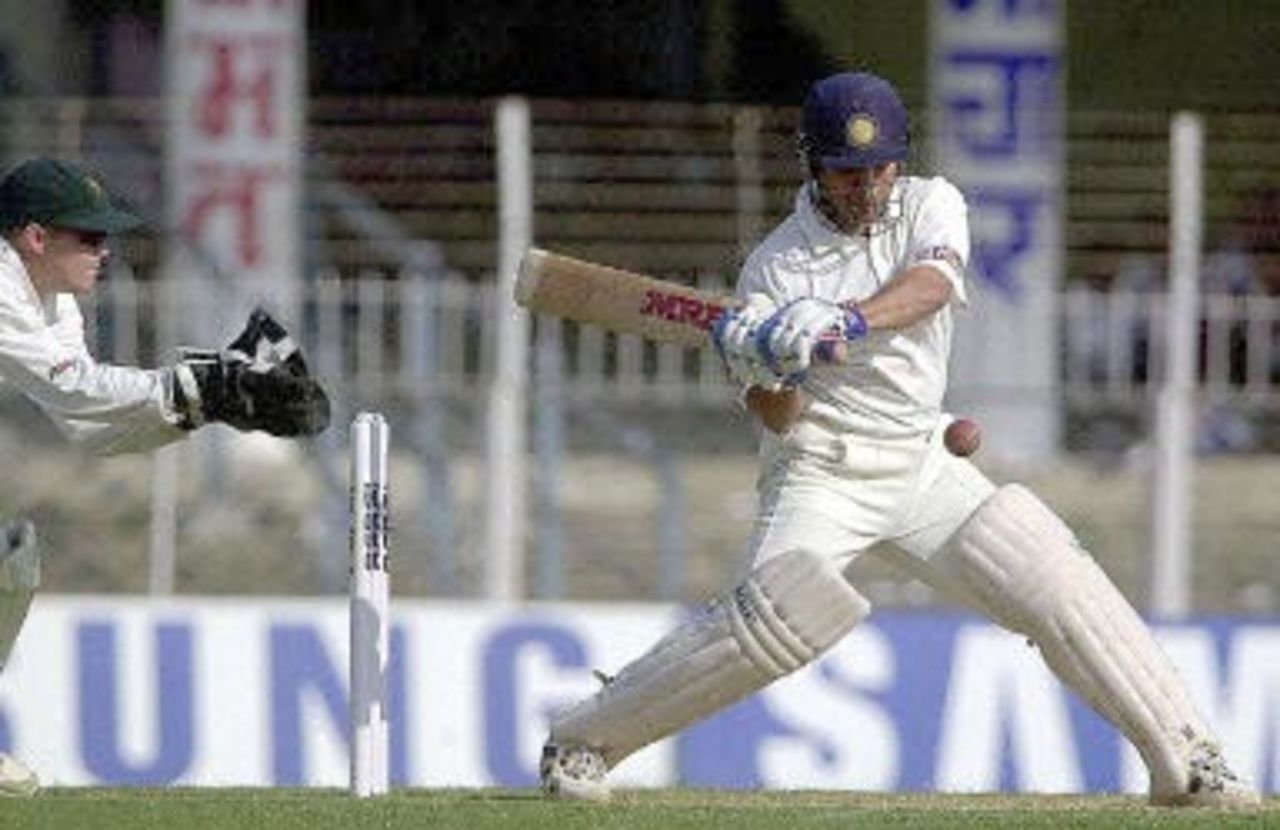 Indian batsman Sachin Tendulkar is about to hit a delivery from Zimbabwe bowler Brian Murphy as wicketkeeper Andy Flower (L) looks on during the first day of the second Test cricket match between India and Zimbabwe in Nagpur, 25 November 2000. Tendulkar scored 49 runs not out and India made 306 for 2 at close of the first day's play. India leads Zimbabwe 1-0 in the two Test series.