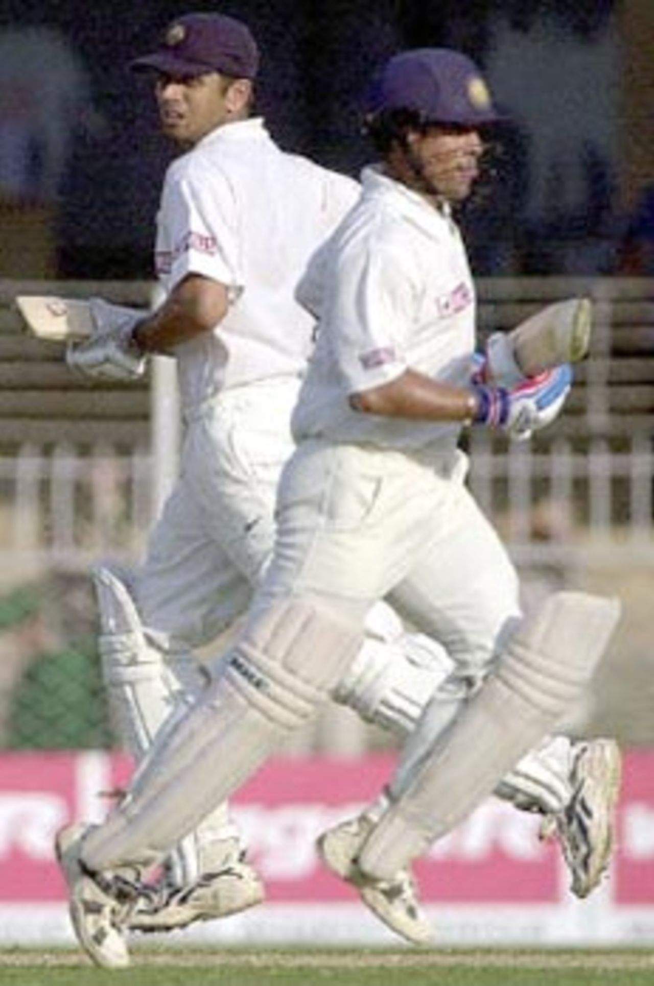 Indian batsmen Rahul Dravid (L) and Sachin Tendulkar pass each other while adding yet another run to the day's tally during the first day of the second Test cricket match between India and Zimbabwe in Nagpur, 25 November 2000. India made 306 for 2 at close of the first day's play. India leads Zimbabwe 1-0 in the two Test series.