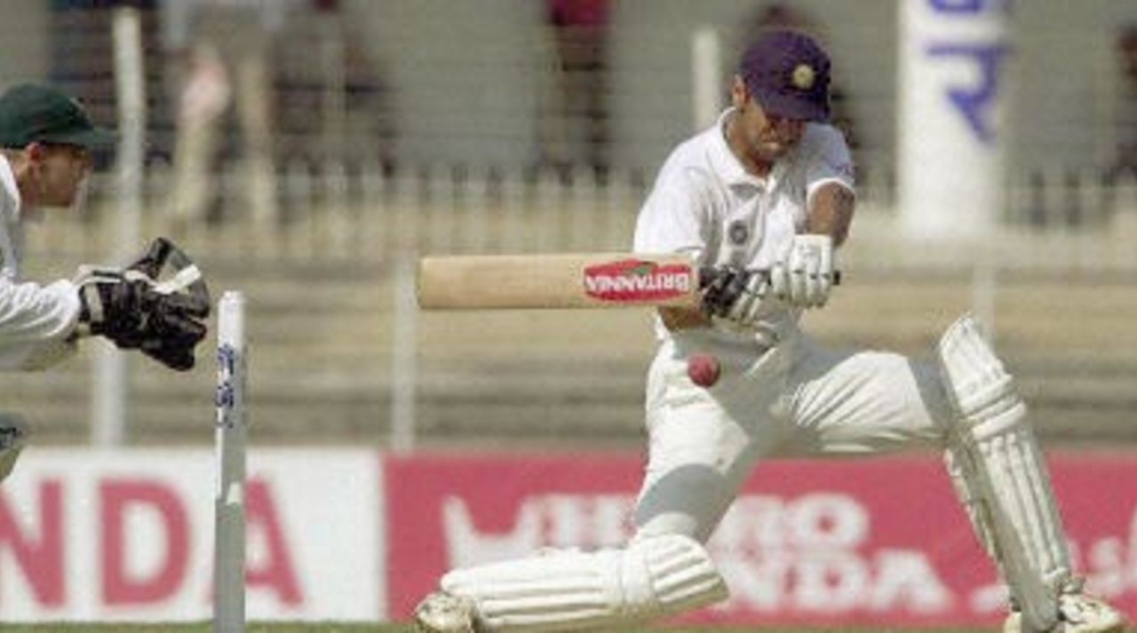 Indian batsman Rahul Dravid hits a four off Zimbabwe bowler Grant Flower (not in the picture) as Zimbabwe wicket keeper Andy Flower (L) looks on during the second day of the second test match between India and Zimbabwe 26 November 2000 in Nagpur. Dravid was unbeaten on 153 runs as India stood at 463 for two by lunch. India is already 1-0 up in the two-test-series against Zimbabwe.