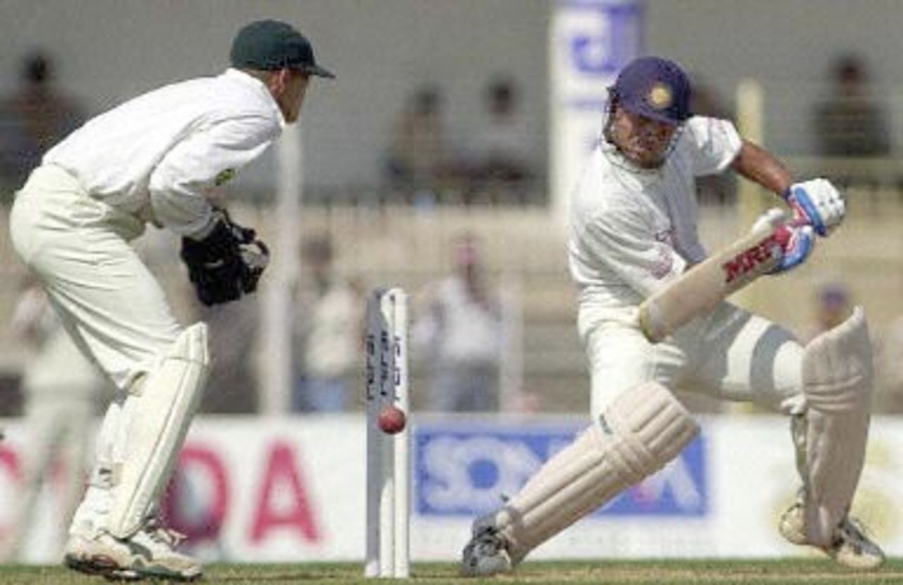 Indian batsman Sachin Tendulkar steers a delivery from Zimbabwe bowler Dirk Viljoen (not in picture) to the fence, as Zimbabwe wicket keeper Andy Flower (L) looks on during the second day of the second test match between India and Zimbabwe 26 November 2000 in Nagpur. Tendulkar was unbeaten on 142 runs as India stood at 463 for two by lunch. India is already 1-0 up in the two-test-series against Zimbabwe.