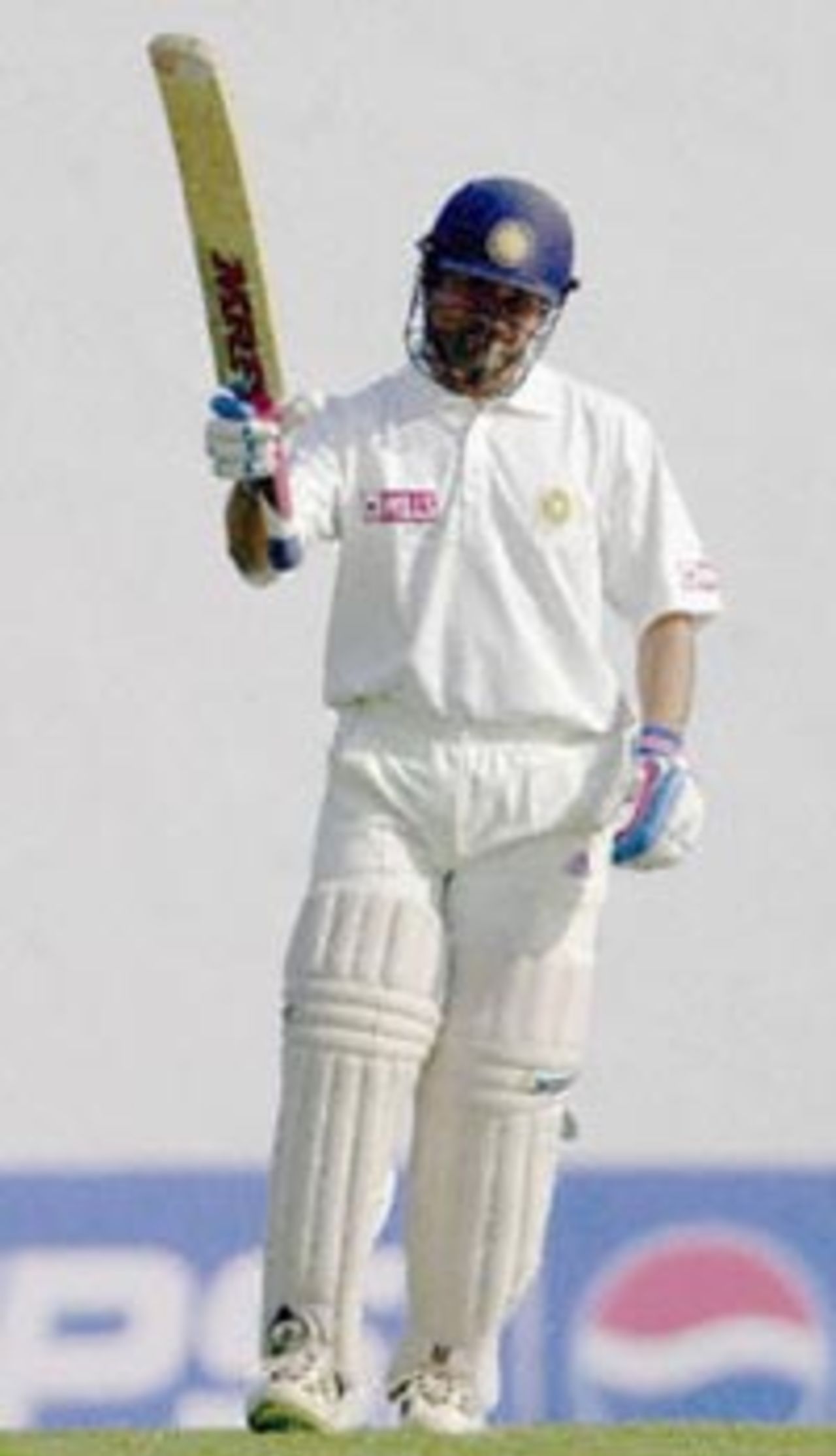 Indian batsman Sachin Tendulkar raises his bat to acknowledge the cheering crowd on the second day of the second test match between India and Zimbabwe 26 November 2000 in Nagpur. Tendulkar was unbeaten on 142 runs as India stood at 463 for two by lunch. India is already 1-0 up in the two-test-series against Zimbabwe.