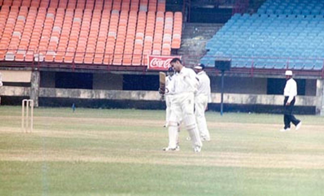 Satyajit Medappa raises his bat after reaching his century. Ranji Trophy South Zone League, 2000/01, Kerala v Goa, Nehru Stadium, Kochi, 15-18 November 2000.