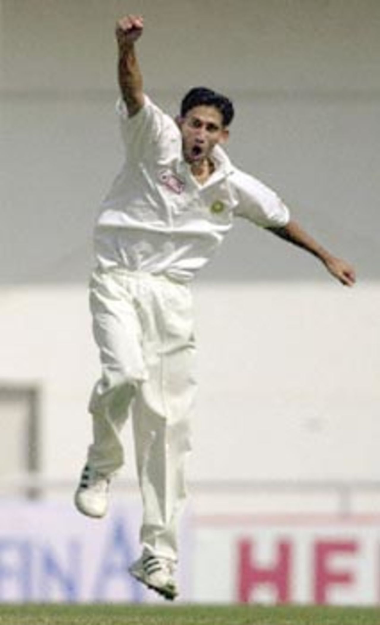 Indian pace bowler Ajit Agarkar punches his fist in the air as he exults after taking Zimbawean batsman Stuart Carlisle's wicket on the third day 27 November 2000 of the second test match between India and Zimbabwe in Nagpur. Carlisle was out for 51 as Zimbabwe stood at 153 for 2 at lunch.