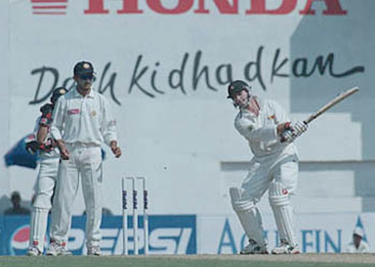 Ganguly watches Whittall as he uses his bat to get rid of an insect, Zimbabwe in India, 2000/01, 2nd Test, India v Zimbabwe, Vidarbha C.A. Ground, Nagpur, 25-29 November 2000 (Day 3).