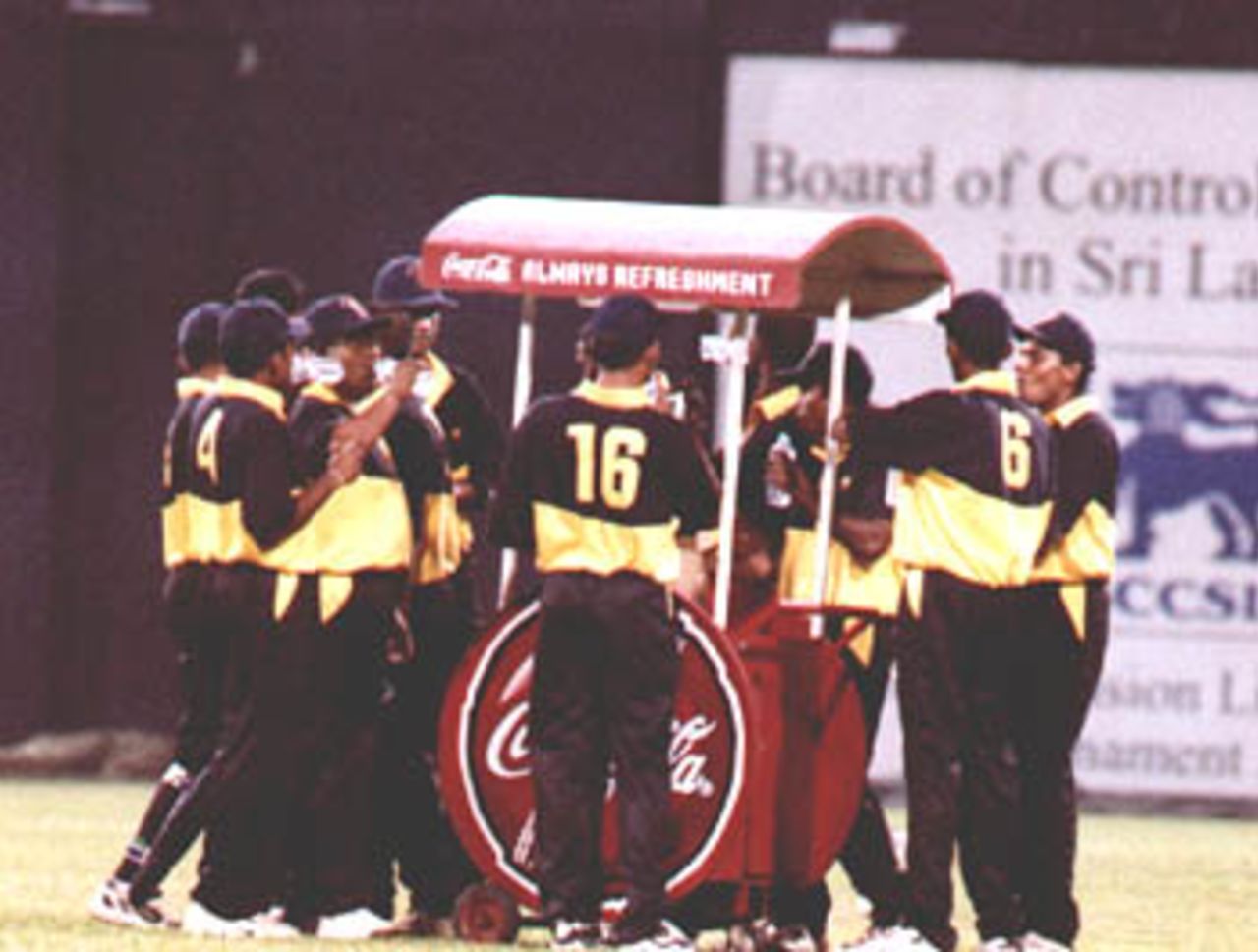 The SSC players gather around the water truck during the CCC vs SSC semi final at Premadasa International Stadium