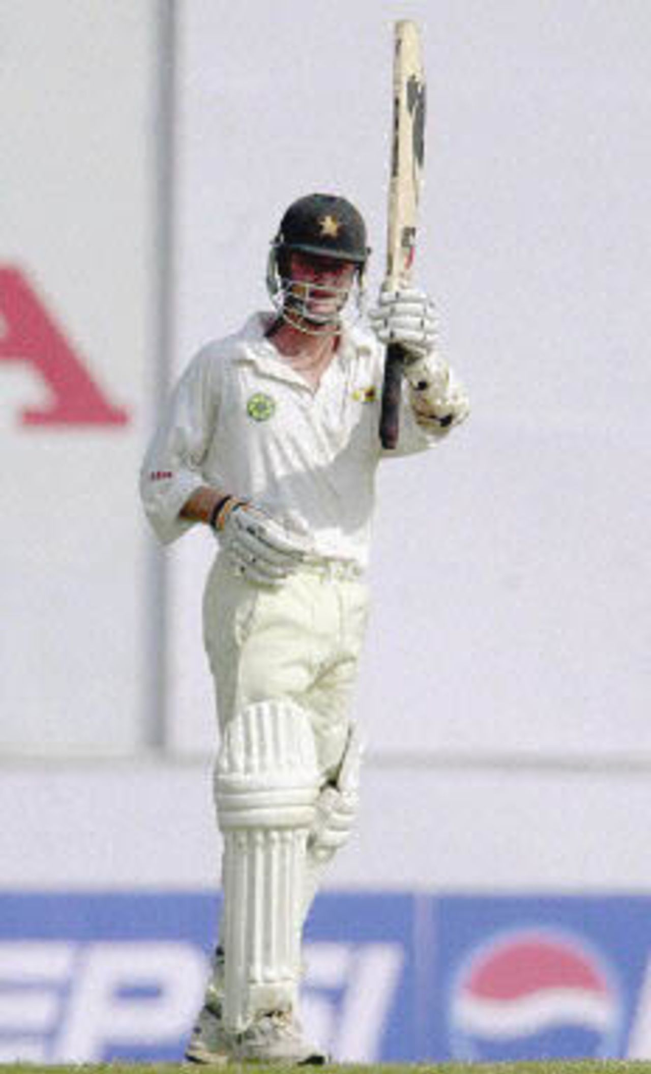 Grant Flower raises his bat in acknowledgement after reaching his century, Zimbabwe in India, 2000/01, 2nd Test, India v Zimbabwe, Vidarbha C.A. Ground, Nagpur, 25-29 November 2000 (Day 4).