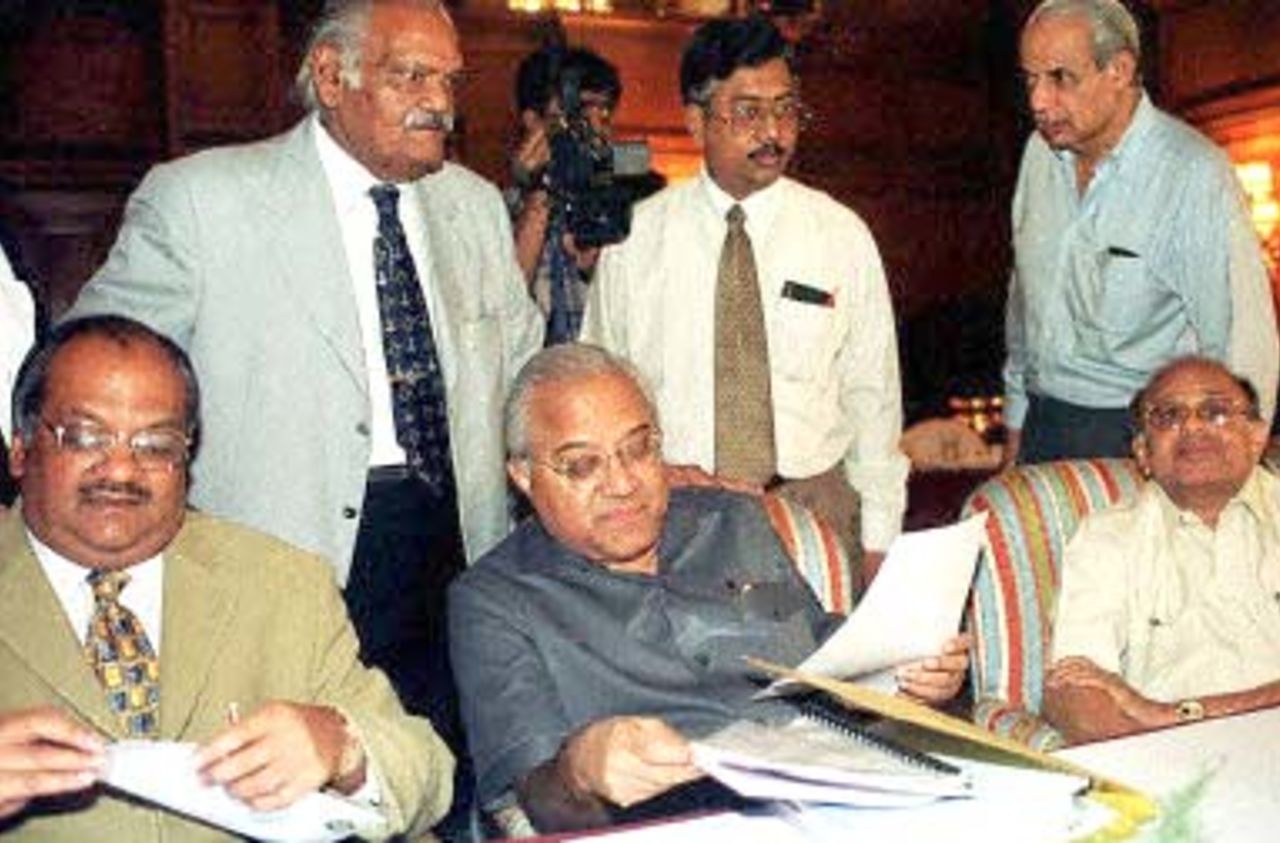 President of the Board of Control for Cricket in India (BCCI) A.C. Muthiah (C, sitting) leafs through documents before the start of GBM in Calcutta, 29 November 2000 to decide the fate of five players tainted by match fixing allegations. At least one of the five players, which includes former skipper Mohammad Azharuddin, was expected to be slapped with a life-ban. BCCI General Secretary J.Y. Lele is at right, sitting, others are unidentified members.