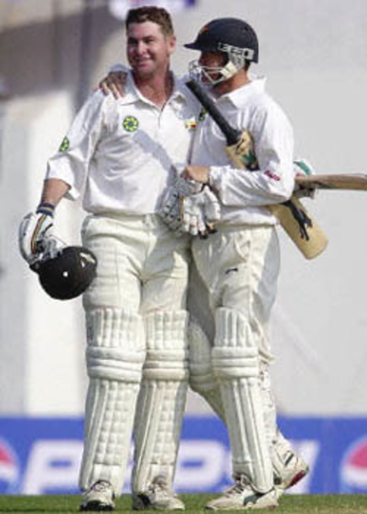 Andy Flower congratulates Alistair Campbell as he scores his first Test hundred, Zimbabwe in India, 2000/01, 2nd Test, India v Zimbabwe, Vidarbha C.A. Ground, Nagpur, 25-29 November 2000 (Day 5).