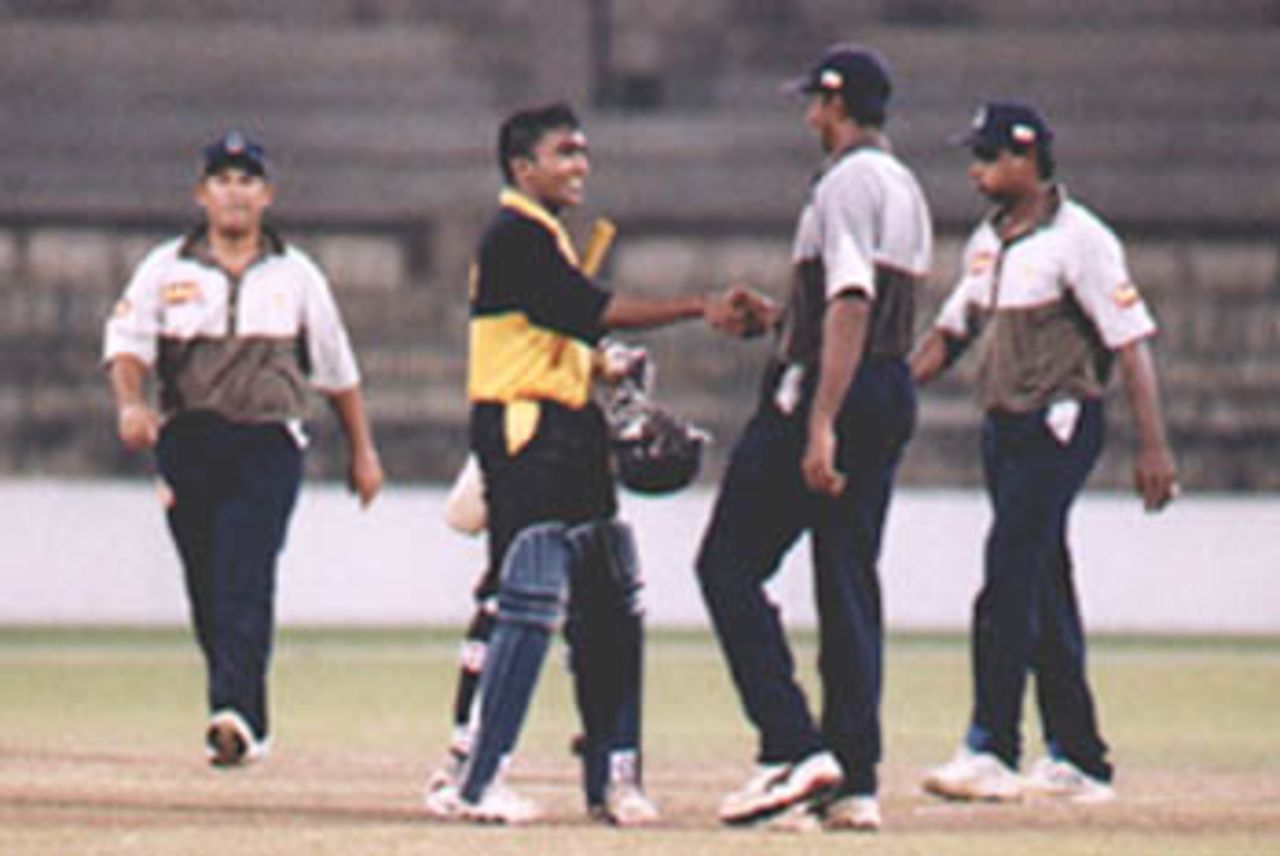 Friends at the end. Mahela shakes hands with member of a disappointed Colts side