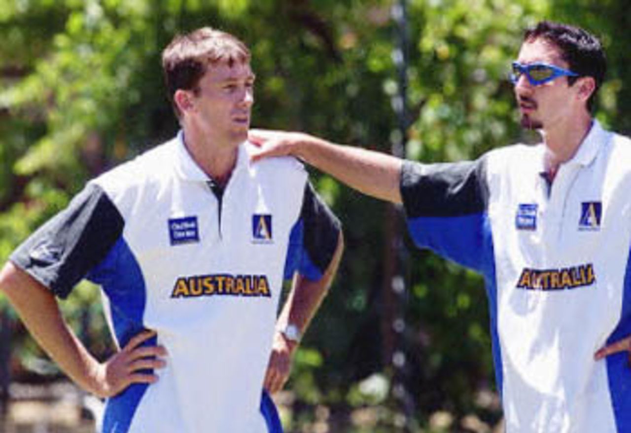 Australian fast bowler Glenn McGrath (L) has a quiet word with countryman Jason Gillespie (R) during a practise session at the WACA ground in Perth, 30 November 2000. McGrath is poised to become the third Australian to reach 300 test wickets, if he can dismiss another two batsmen in the second test against the West Indies in Perth from the first to the fifth of December, with fellow fast bowler Gillespie likely to be recalled after injury.