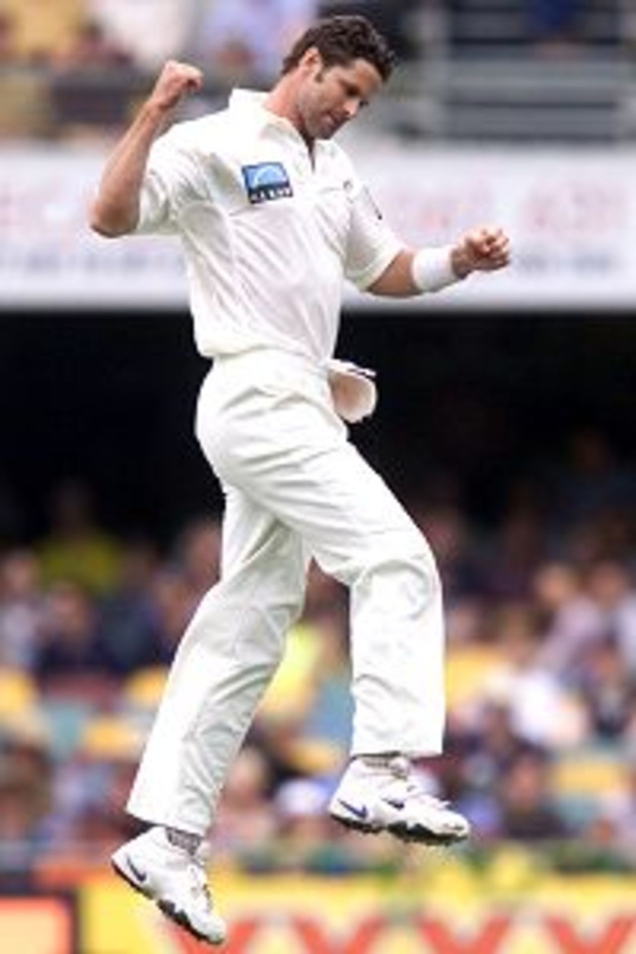 09 Nov 2001: Chris Cairns of New Zealand celebrates the wicket of Shane Warne of Australia during the second day of play in the first Test between Australia and New Zealand being played at the Gabba, Brisbane, Australia.