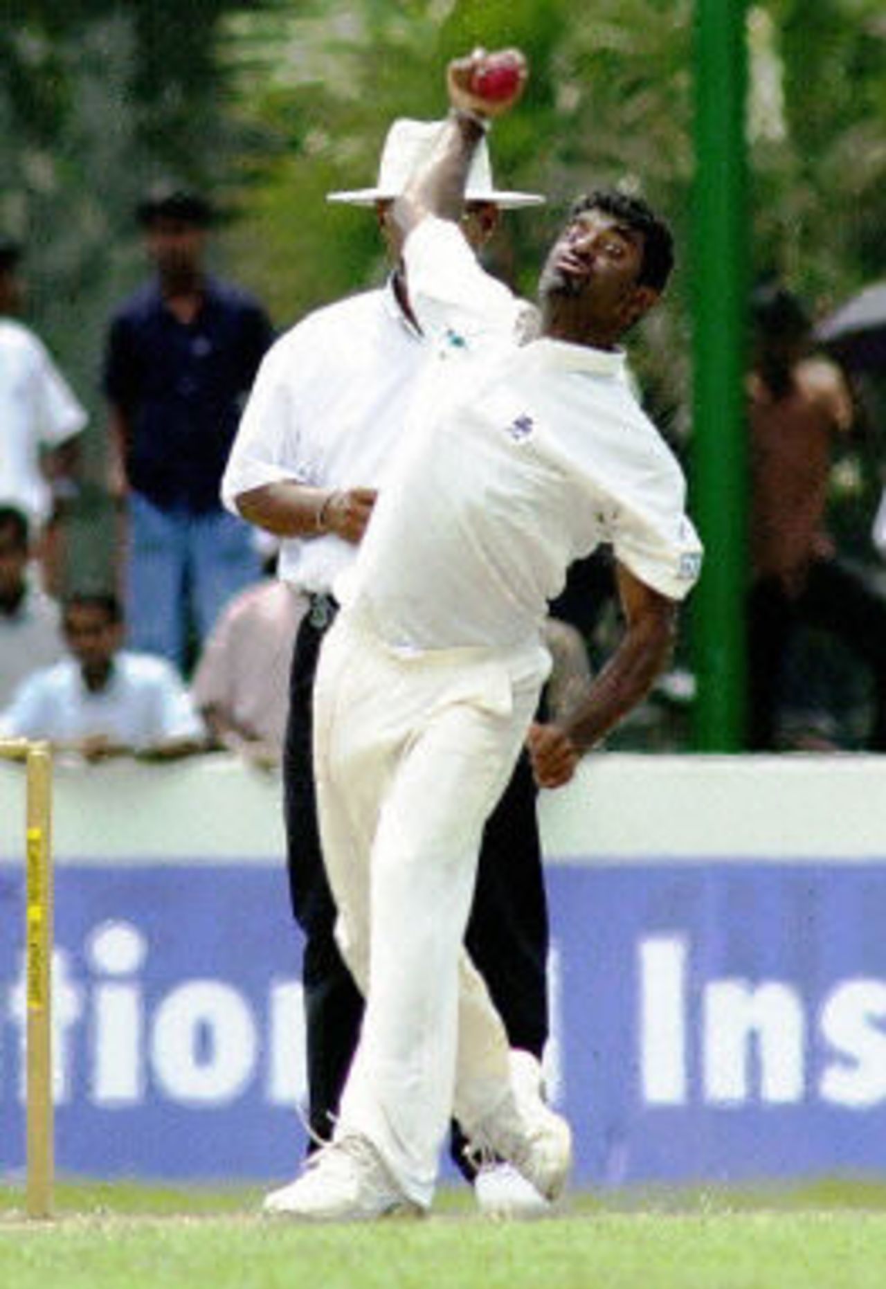 Muttiah Muralidharan delivers a ball during the final day of the first cricket test match between Sri Lanka and West Indies