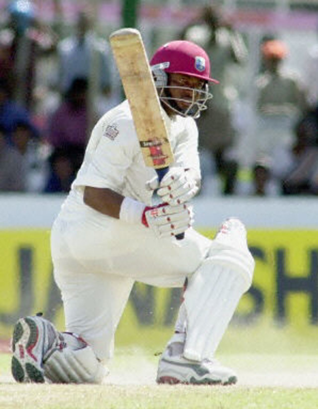Brian Lara sweeps a ball to the boundary during the final day of the first cricket test match between Sri Lanka and West Indies