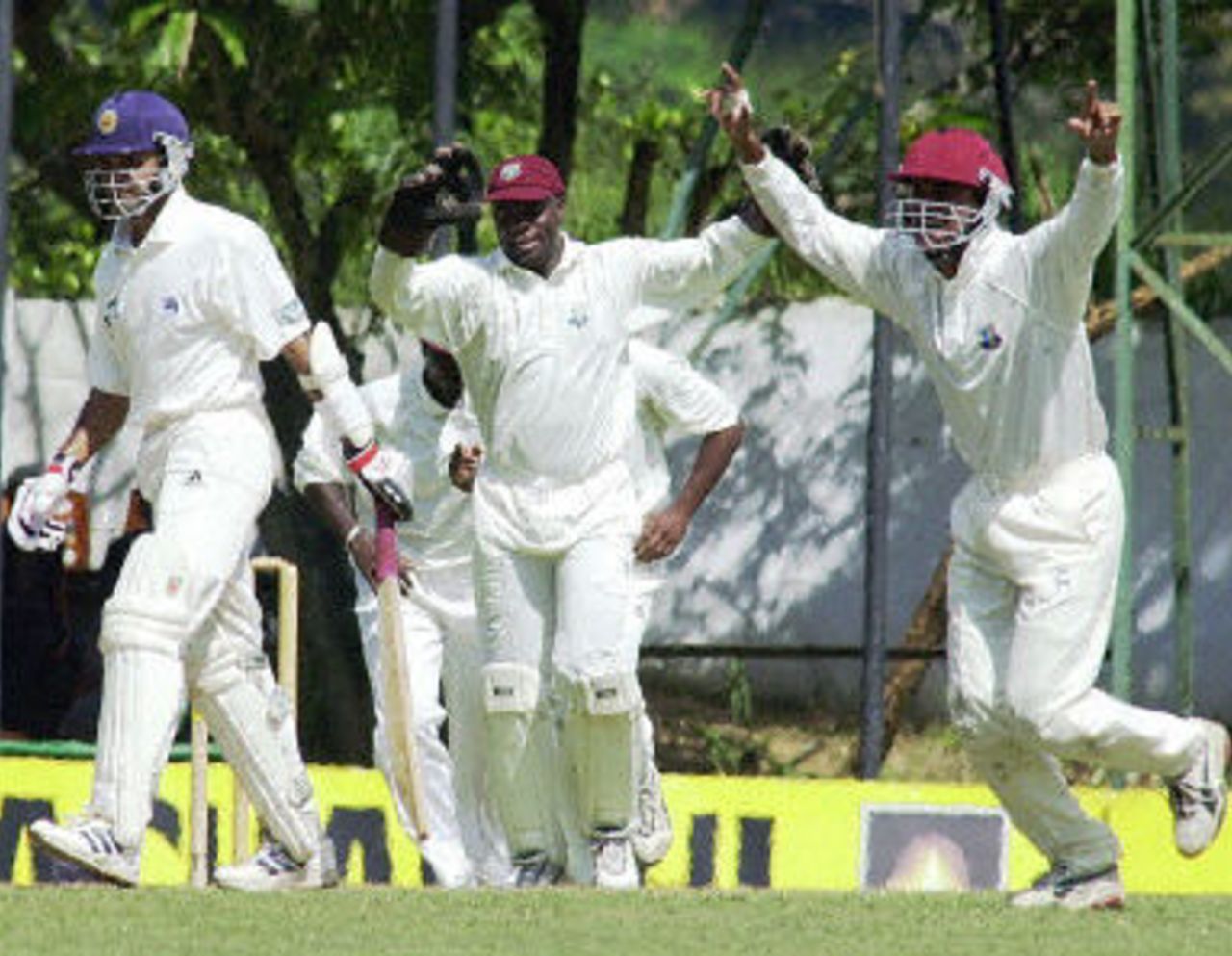 Ridley Jacobs and Darren Ganga celebrate the dismissal of Sri Lankan batsman Marvan Atapattu