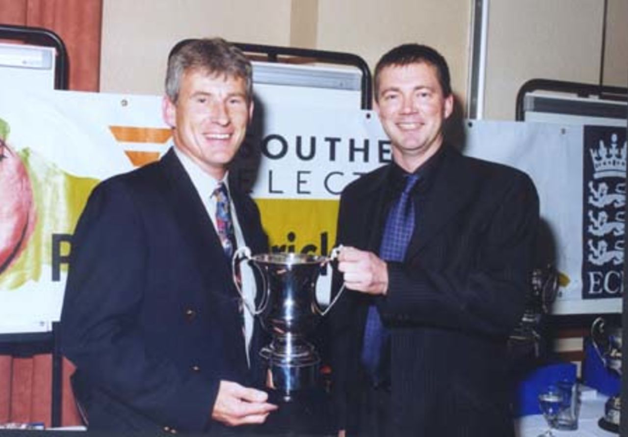 Portsmouth's Pete Hayward receives the Division II Championship Trophy from Barry Williams