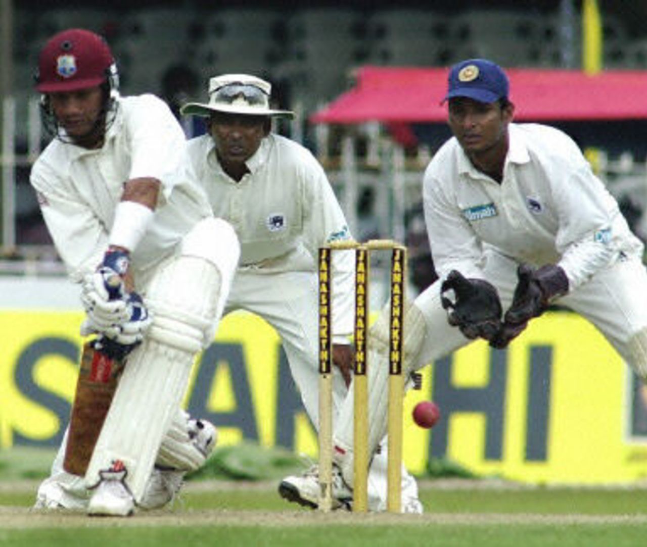 Ramnaresh Sarwan defends a ball as Sangakkara and Jayawardane looks on during the first day of thirdTest match between Sri Lanka and West Indies, SSC Colombo