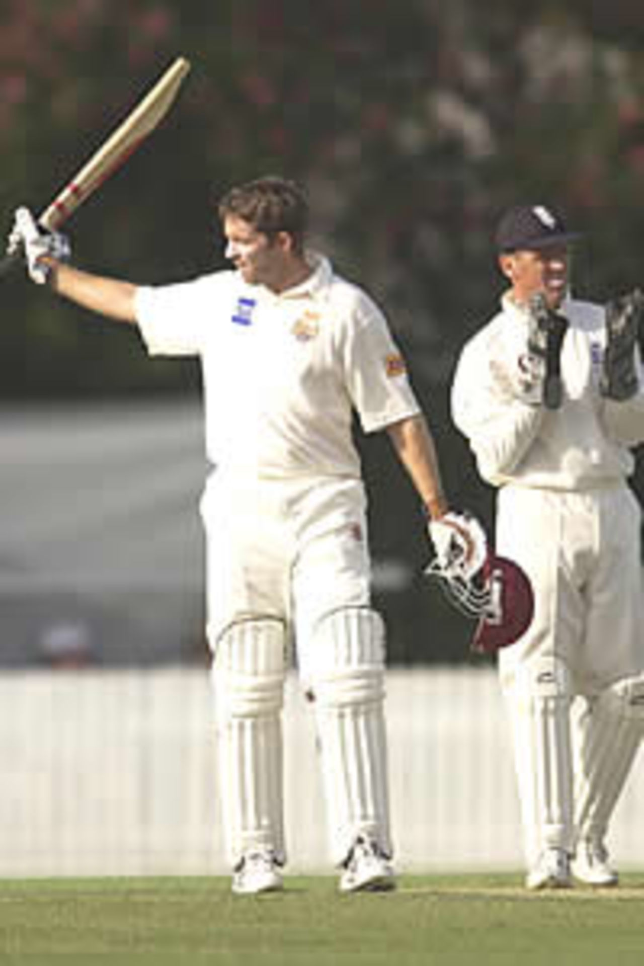 BRISBANE - NOVEMBER 2: Martin Love of Queensland celebrates reaching his century during the three day tour match between Queensland and England at the Allan Border Field in Brisbane, Australia on November 2, 2002.