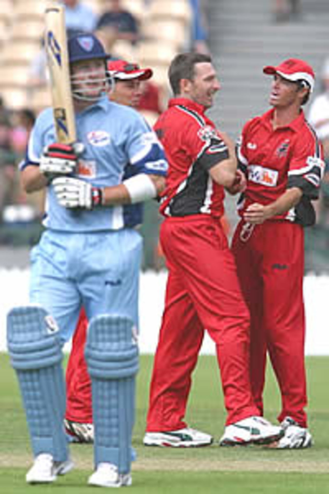 ADELAIDE - NOVEMBER 2: Damien Fleming is congratulated by Greg Blewett and Darren Lehmann after he bowled Michael Clarke for 48 during the ING Cup match between the South Australian Redbacks and New South Wales Blues played at Adelaide Oval in Adelaide, Australia on November 2, 2002.