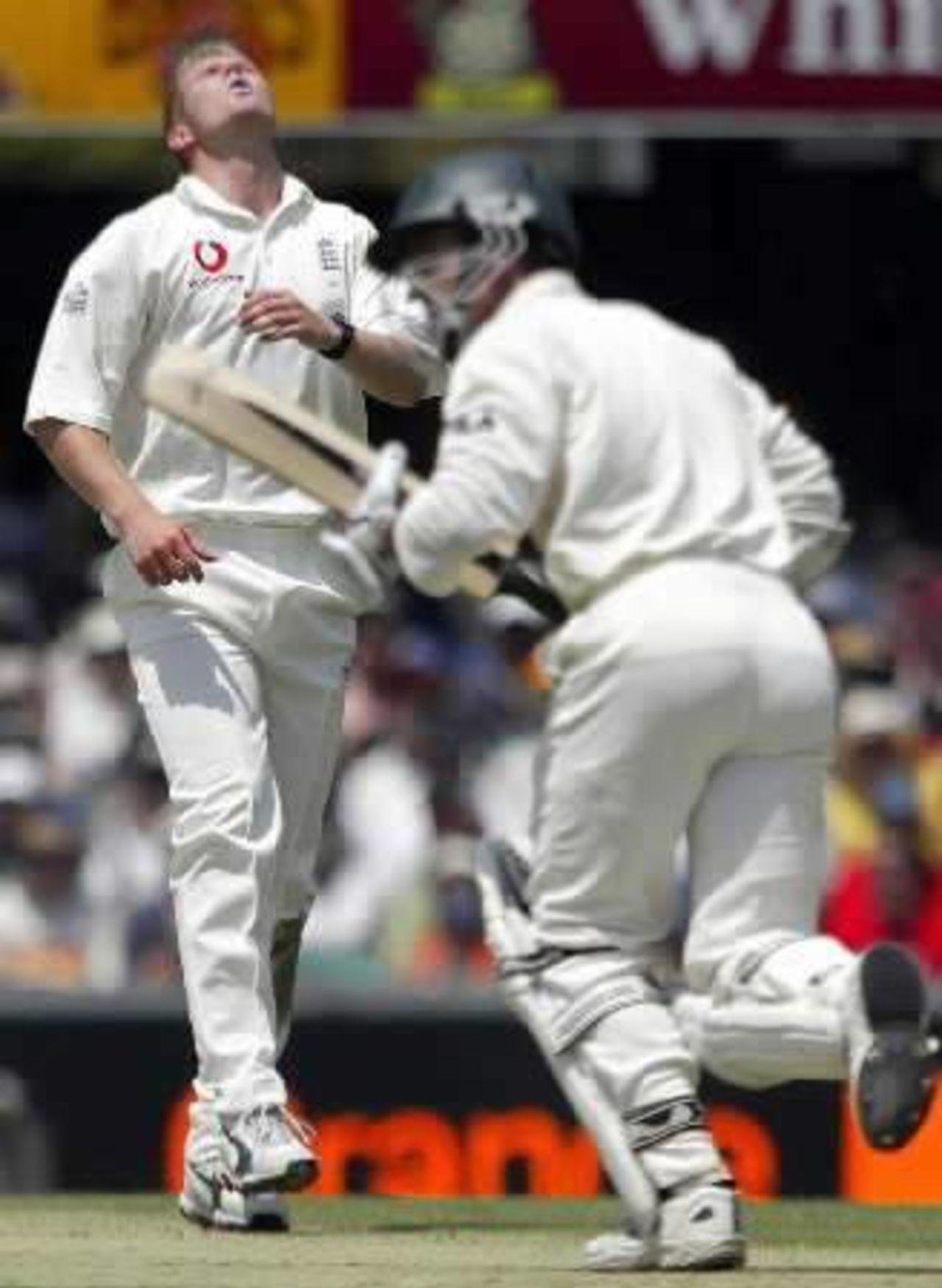 Australia's Justin Langer (R) hits England's Matthew Hoggard (L) for four on the opening morning of the first Ashes test in Brisbane