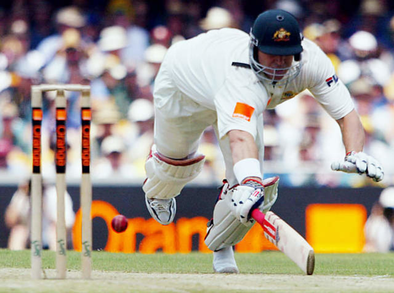 Australia's Matthew Hayden dives to make his ground during the first day's play in the first Ashes test match against England at the Gabba in Brisbane November 7, 2002.